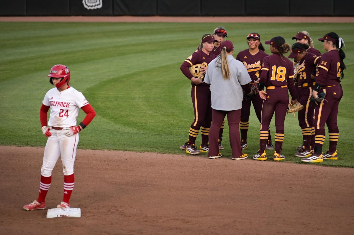 The Sundevil infield meets in the outfield while sophomore infielder Taryn Massey stands on second during the game against Arizona State at Dail Softball Stadium on Wednesday, March 25, 2026. The Wolfpack fell to the Sundevils 7-3.
