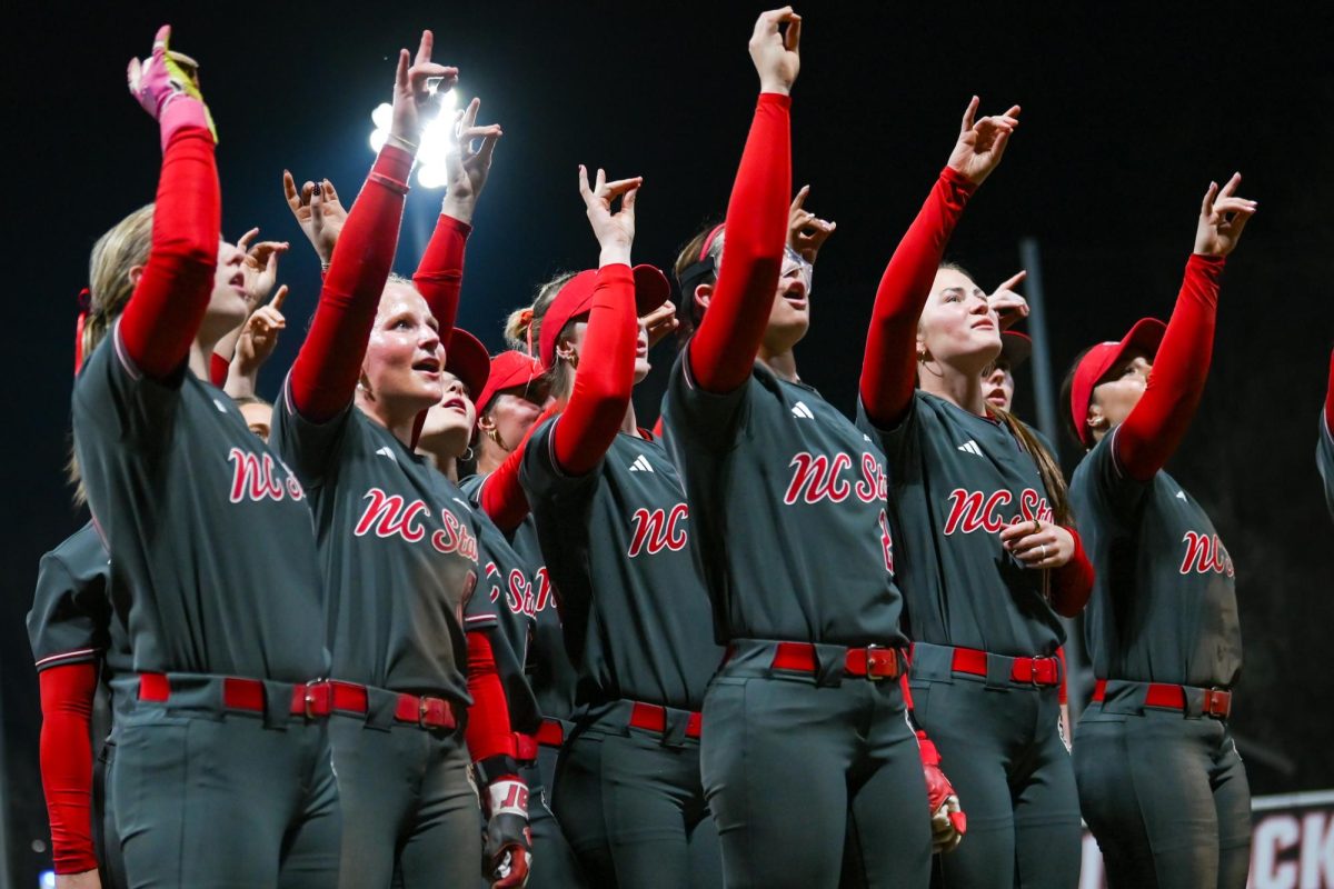 The NC State Softball team throws up "wolfies" after the game against Mercer at Dail Softball Stadium on Friday, Mar. 6, 2026. The Wolfpack defeated the Bears 8-0.