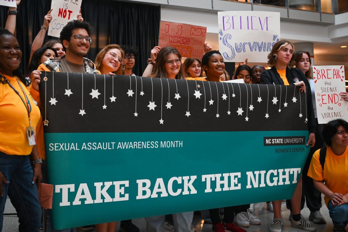 Participants pose with a banner during Take Back The Night in Talley Student Union on Thursday, April 11, 2024. Take Back The Night is an annual event that is held to honor survivors of sexual assault. 