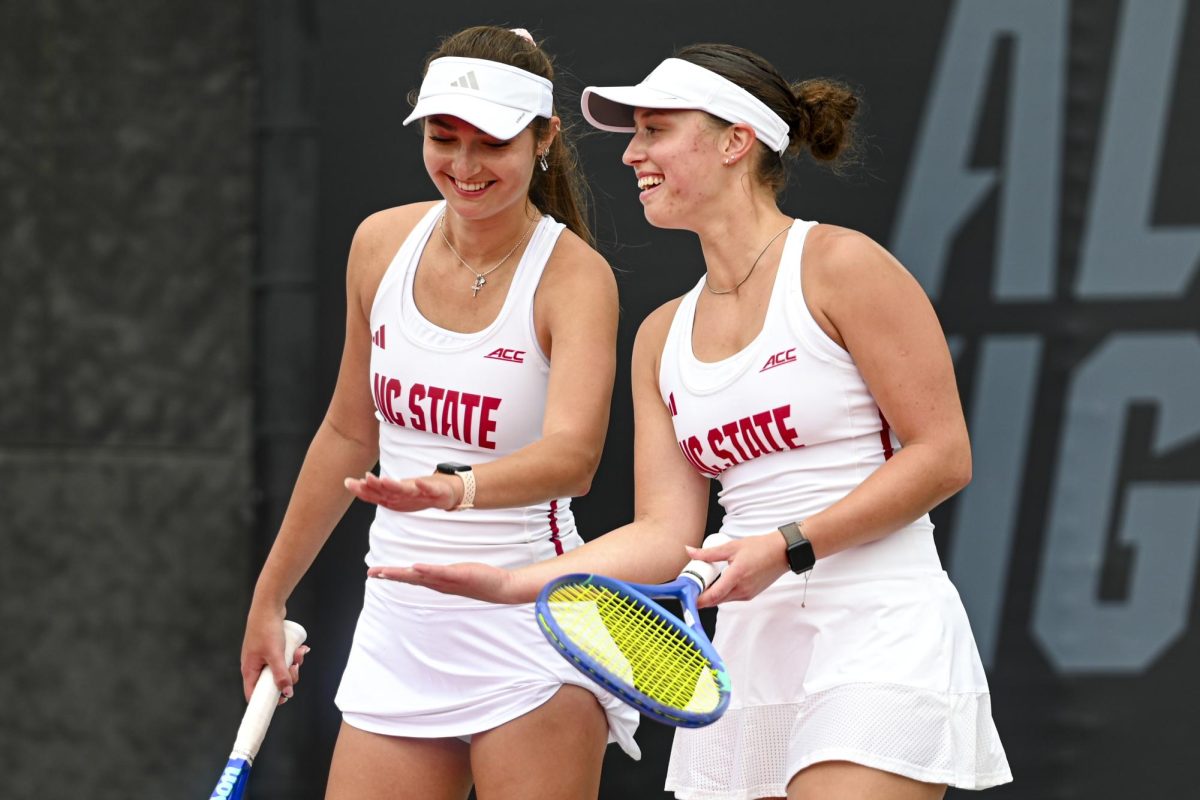 Junior Jasmine Conway and senior Anna Zyryanova high-five during the match against Miami at Dail Outdoor Tennis Stadium on Sunday, March 8, 2026. Conway and Zyryanova won their doubles match 6-3. NC State lost to Miami 4-3.