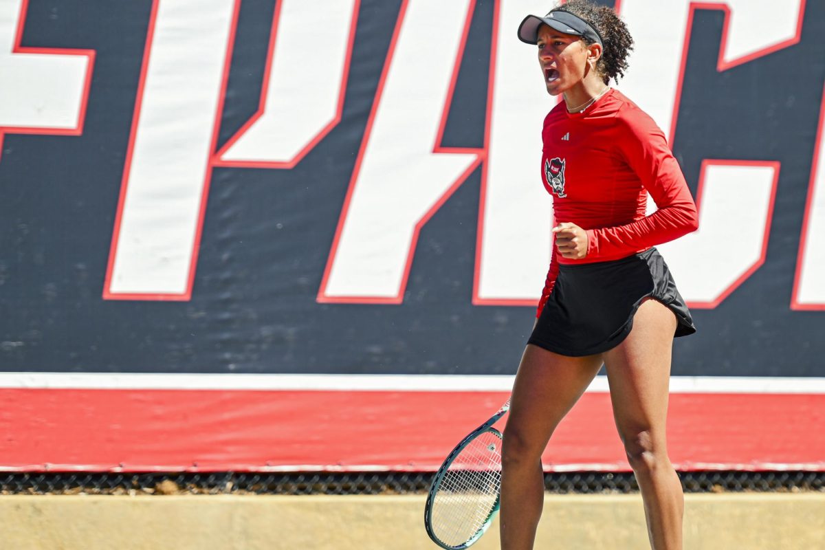 Freshman Victoria Osuigwe does a cheer after scoring during the match against Syracuse at Dail Outdoor Tennis Stadium on Sunday, March 29, 2026. Osuigwe won her singles match (6-1, 6-1). NC State beat Syracuse 7-0.