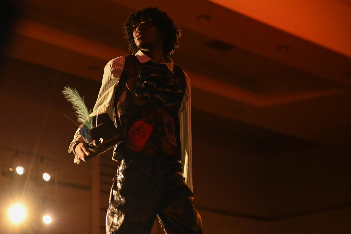 The model for Brooklyn Brown, a first-year studying fashion and apparel design, and Peter Centeno, a first-year studying fashion and textile design, display their work during the African American Textile Society Fashion Exposé at Talley State Ballroom on Monday, April. 20, 2026. This was the African American Textile Society 28th Annual Fashion Exposé focusing on culture and Heritage. 
