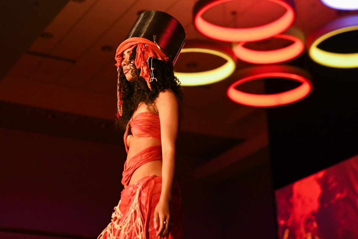 he model for Brooklyn Brown, a first-year studying fashion and apparel design, and Peter Centeno, a first-year studying fashion and textile design, display their work during the African American Textile Society Fashion Exposé at Talley State Ballroom on Monday, April. 20, 2026. This was the African American Textile Society 28th Annual Fashion Exposé focusing on culture and Heritage. 