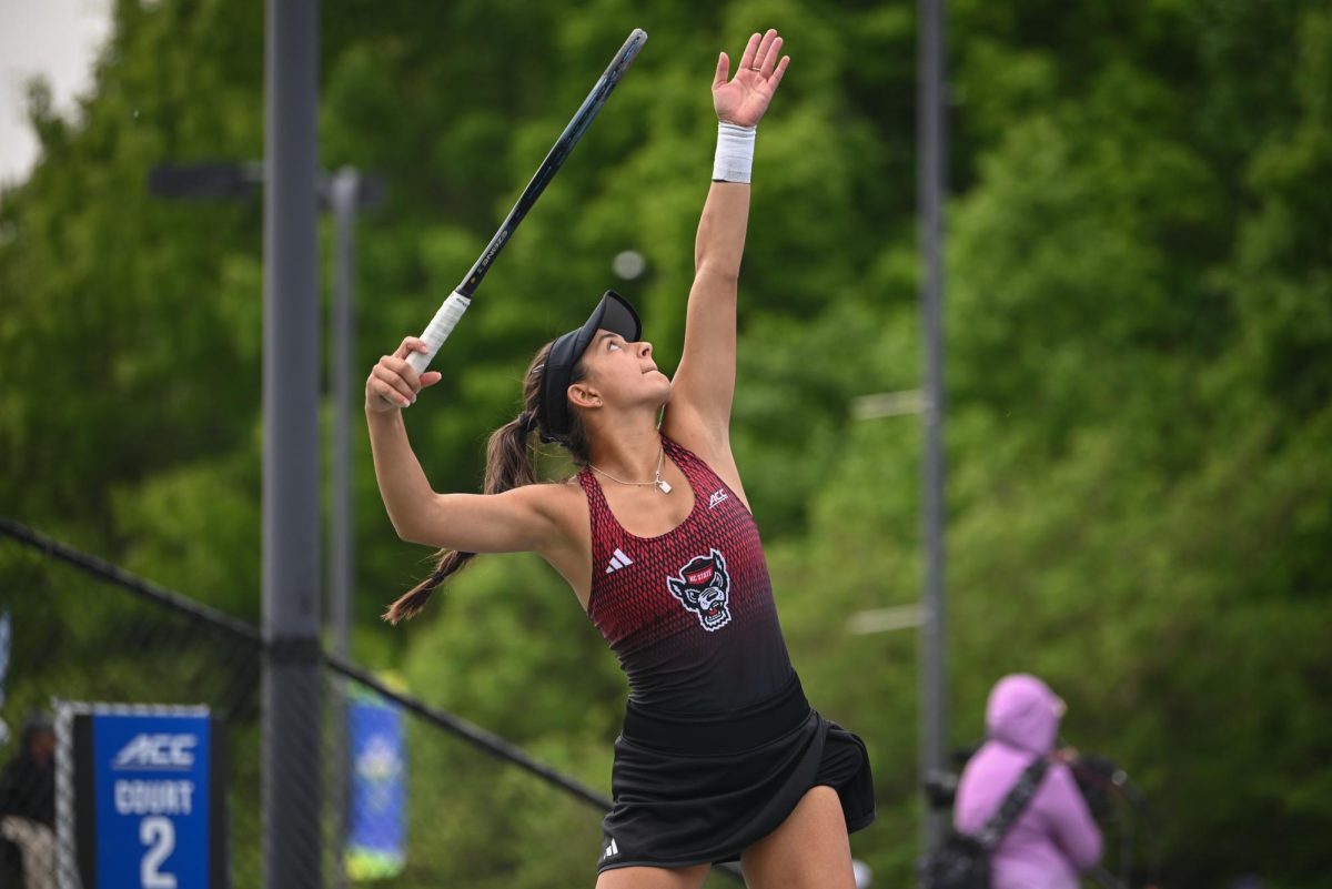 Freshman Lavinia Tanasie serves during the match against UVA in the ACC Women's Tennis Championship at Cary Tennis Park on Sunday, April 19, 2026. The Wolfpack defeated the Cavaliers by a score of 4-0, winning the 2026 ACC Championship. 