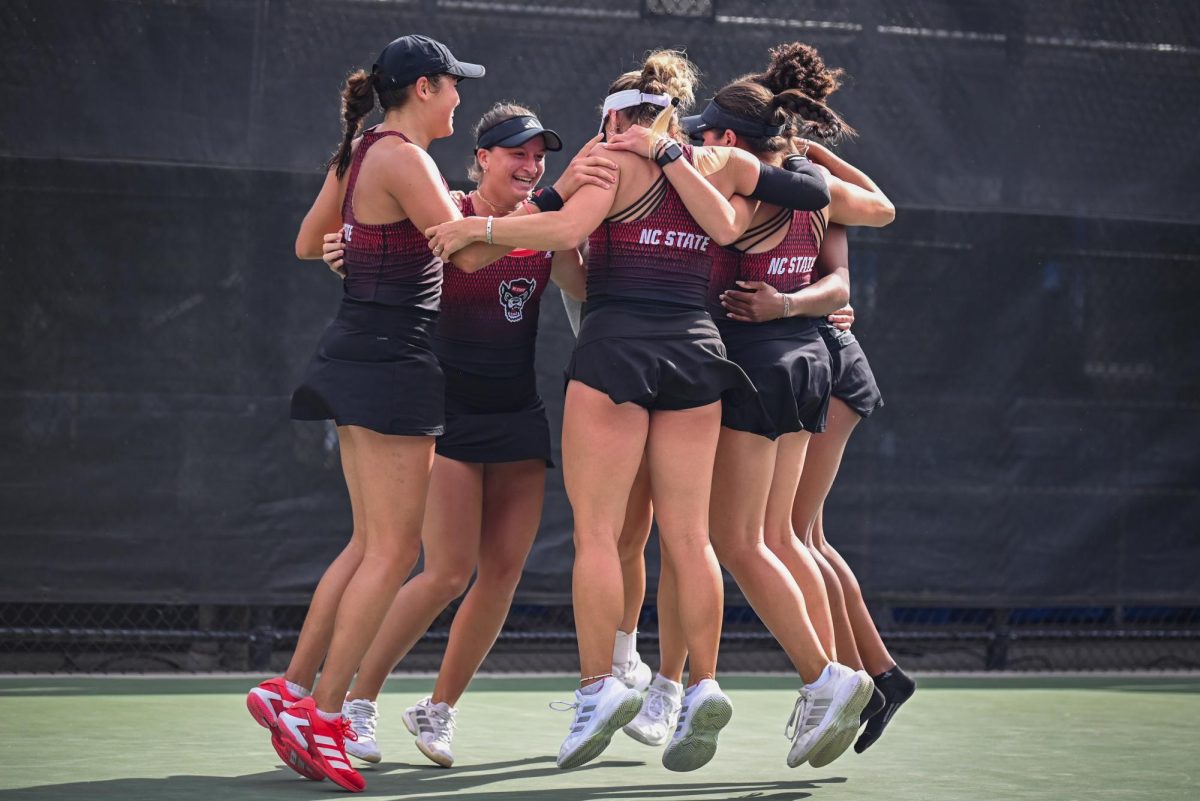 The team celebrates their win in the match against UVA in the ACC Women's Tennis Championship at Cary Tennis Park on Sunday, April 19, 2026. The Wolfpack defeated the Cavaliers by a score of 4-0, winning the 2026 ACC Championship. 