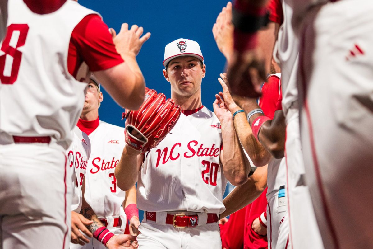 Junior left-handed pitcher Ryan Marohn high-fives his teammates as he comes off the field during the game against Duke at Doak Field at Dail Park on Friday, April 10, 2026. Marohn pitched 5.2 innings, recording nine strikeouts. The Wolfpack beat the Blue Devils 10-4.