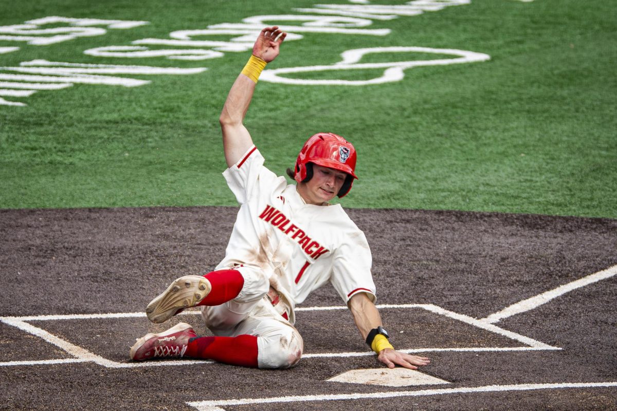 Freshman outfielder Everett Johnson slides into home plate during the game against Duke at Doak Field at Dail Park on Saturday, April 11, 2026. Johnson had four hits and scored four runs. The Wolfpack defeated the Blue Devils 18-5.