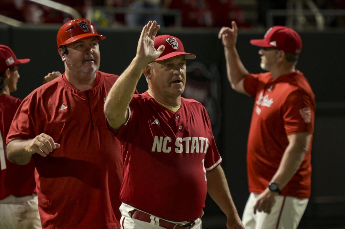 NC State Baseball Head Coach Elliott Avent high fives players after the game against Notre Dame at Doak Field at Dail Park on Thursday, April 4, 2026. NC State defeated Notre Dame 7-3.