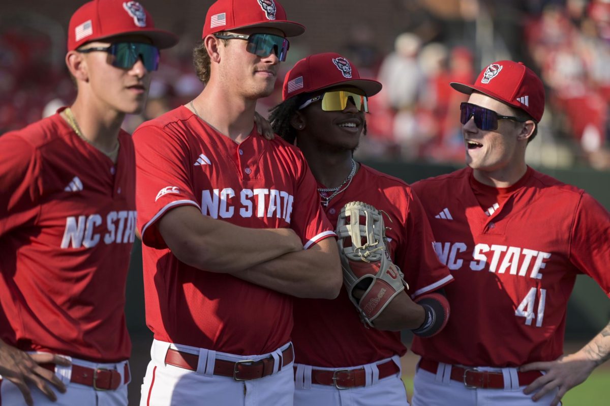 Redshirt freshman right-handed pitcher Kaden Morris, sophomore right-handed pitcher Ryder Garino, junior outfielder  Andrew Wiggins and junior pitcher Jacob Dudan wait for the opposing team's lineup before the game against Notre Dame at Doak Field at Dail Park on Thursday, April 4, 2026. NC State defeated Notre Dame 7-3.
