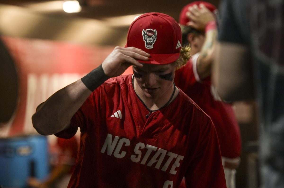 Junior infielder Luke Nixon steadies his cap during the game against Notre Dame at Doak Field at Dail Park on Thursday, April 4, 2026. NC State defeated Notre Dame 7-3.