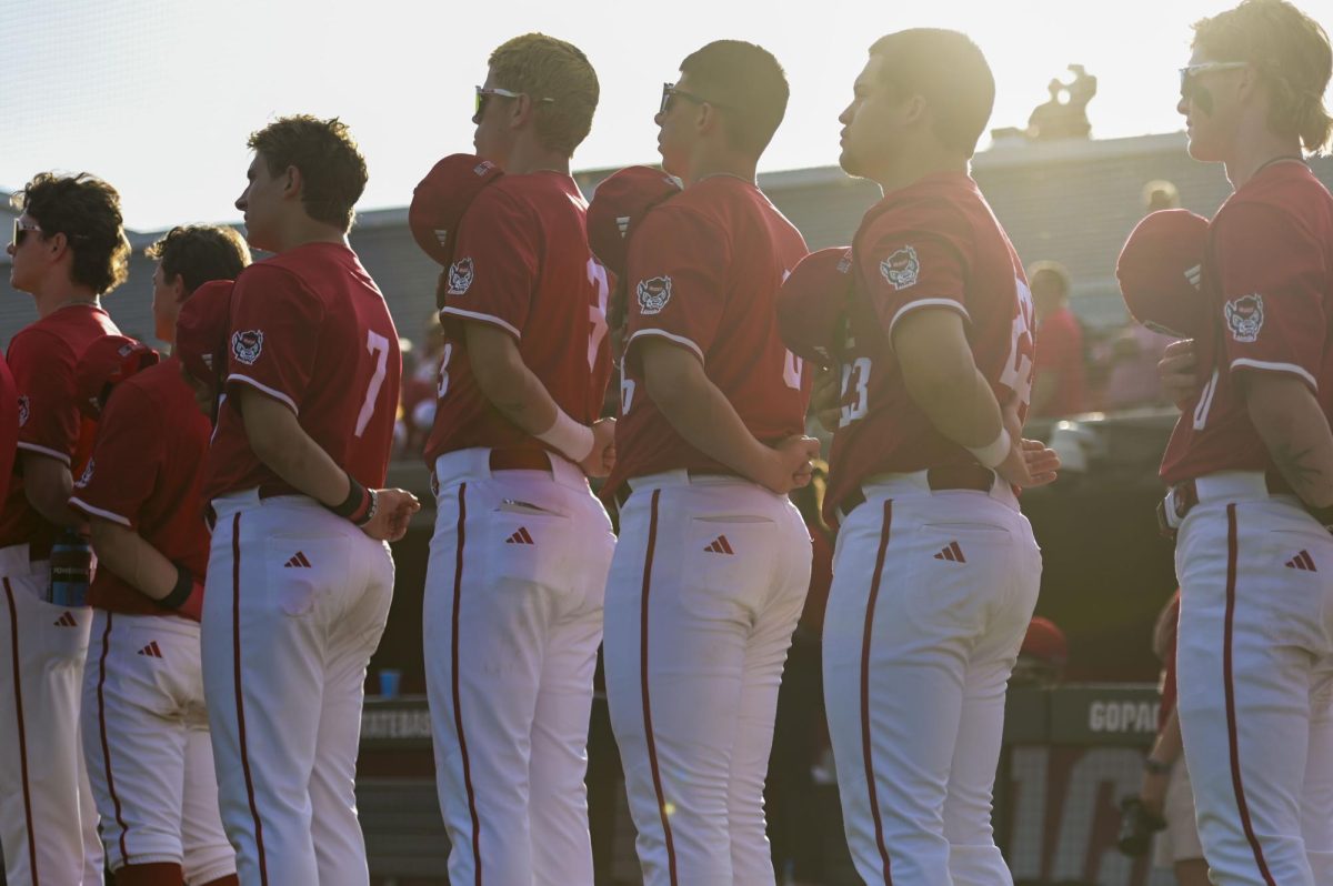 NC State baseball players stand for the national anthem before the game against Notre Dame at Doak Field at Dail Park on Thursday, April 4, 2026. NC State defeated Notre Dame 7-3.
