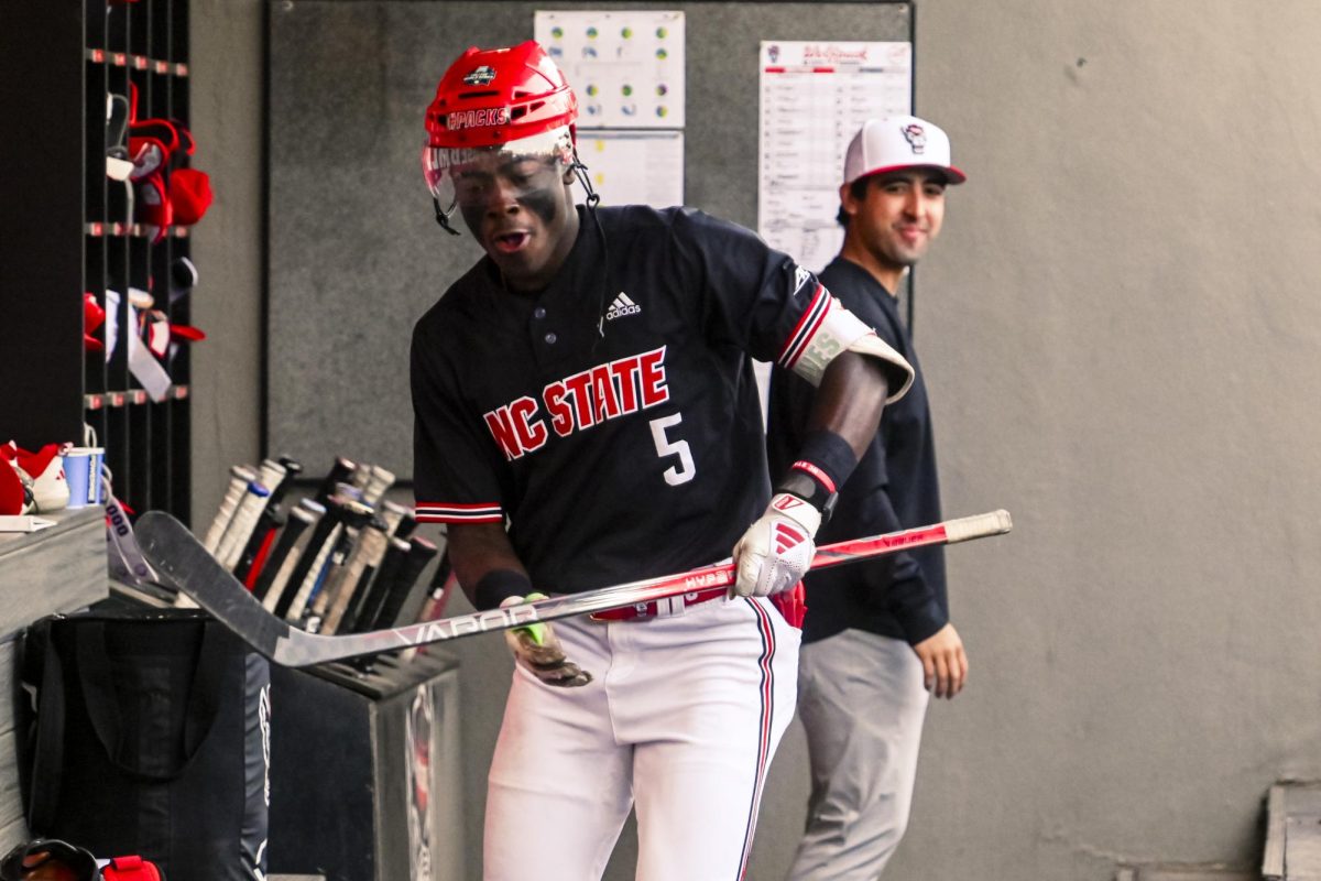 Junior infielder Sherman Johnson celebrates his home run in the dugout during the game against UNCW at Doak Field at Dail Park on Tuesday, April 7, 2026. Johnson hit two home runs in this game. The Wolfpack defeated the Seahawks 7-4.