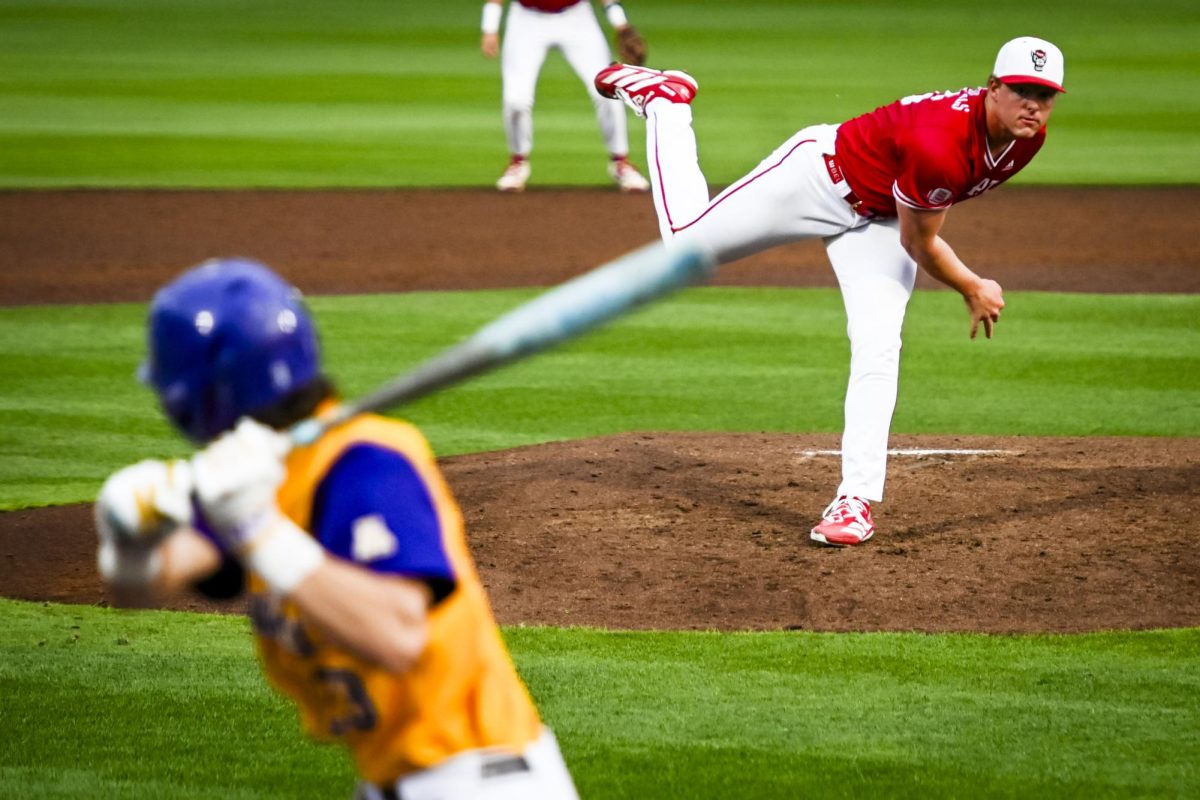 Redshirt-freshman right-hand pitcher Truitt Manuel launches a pitch to the plate during the game against ECU at Doak Field at Dail Park on Tuesday, April 28, 2026. Manuel threw for 2.1 innings, recording five strikeouts. The Wolfpack defeated the Pirates 12-2.
