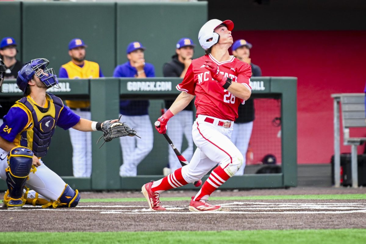 Freshman outfielder Rett Johnson watches the ball fly during the game against ECU at Doak Field at Dail Park on Tuesday, April 28, 2026. Johnson batted four times, recording two runs and one hit. The Wolfpack defeated the Pirates 12-2.