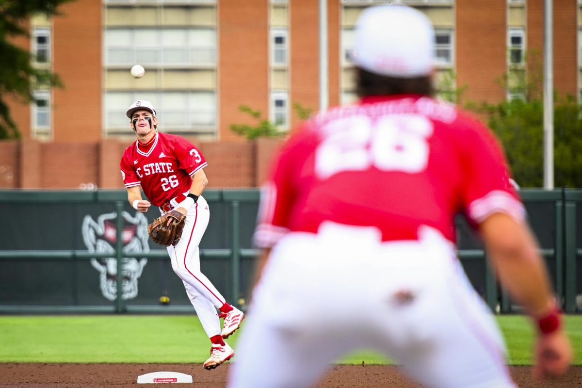 Freshman infielder Christian Serrano throws to first during the game against ECU at Doak Field at Dail Park on Tuesday, April 28, 2026. The Wolfpack defeated the Pirates 12-2.