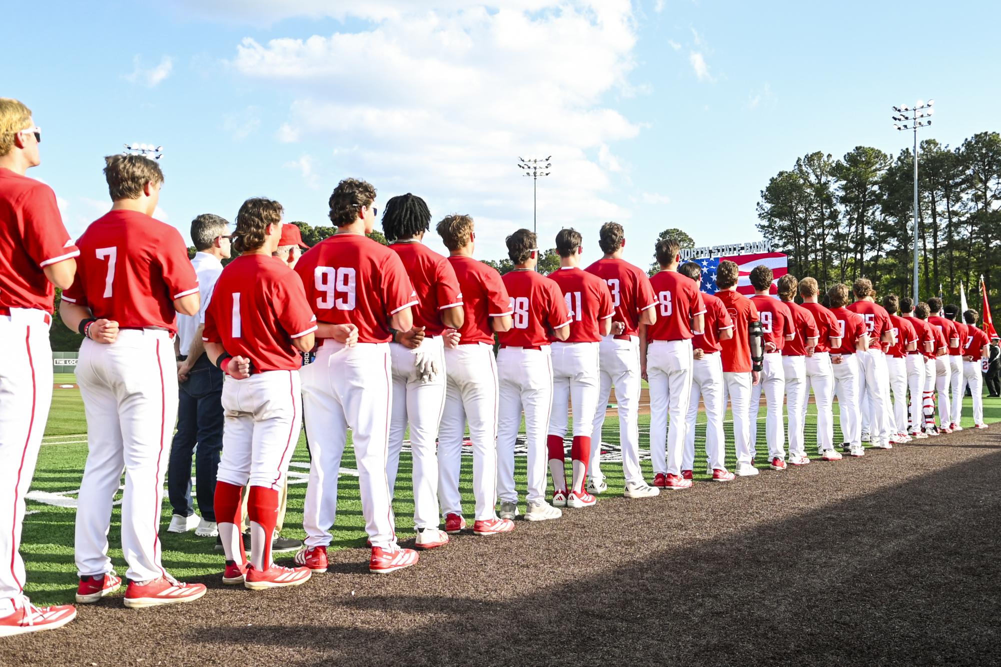 NC State players stand together for the playing of the national anthem during the game against Notre Dame at Doak Field at Dail Park on Thursday, April 4, 2026. NC State defeated Notre Dame 7-3.