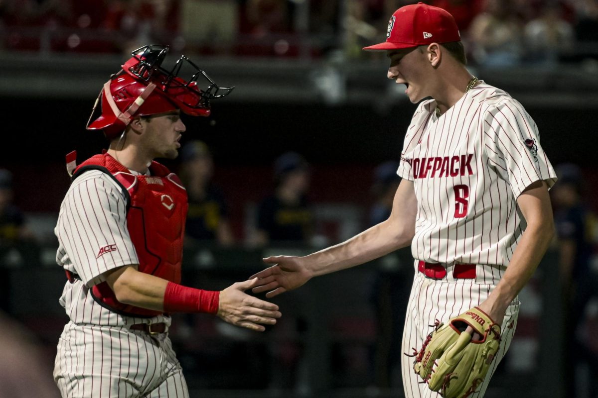 Redshirt junior catcher Drew Lanphere and sophomore right-hand pitcher Ryder Garino high-five after Garino threw a strikeout during the game against Notre Dame at Doak Field at Dail Park on Friday, April 3, 2026. NC State defeated Notre Dame 7-3.