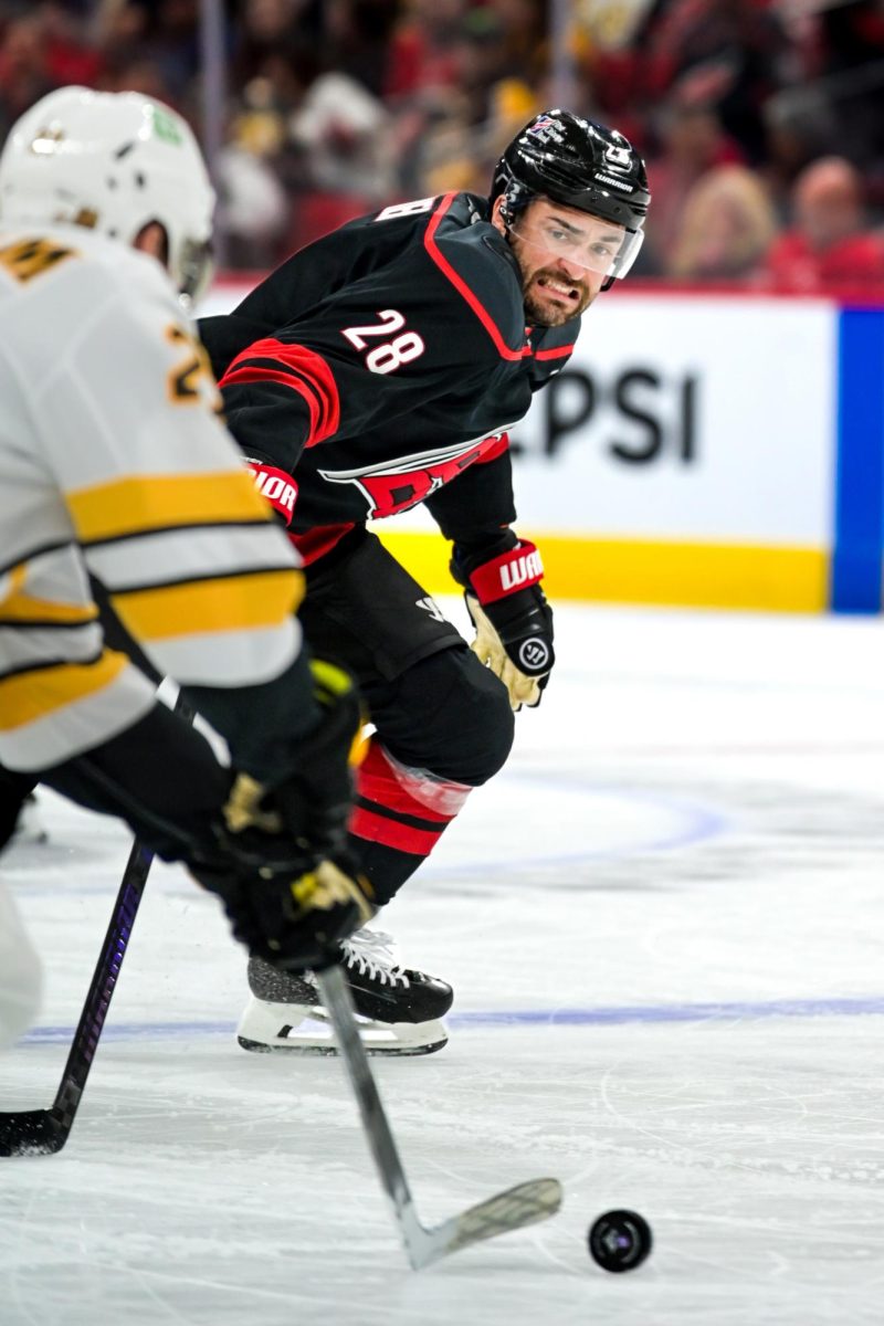 Left wing William Carrier struggles to gain possession of the puck after a face-off during the game versus the Boston Bruins at the Lenovo Center on Tuesday, April 7, 2026. Carrier had one goal. The Canes defeated the Bruins in OT 6-5.