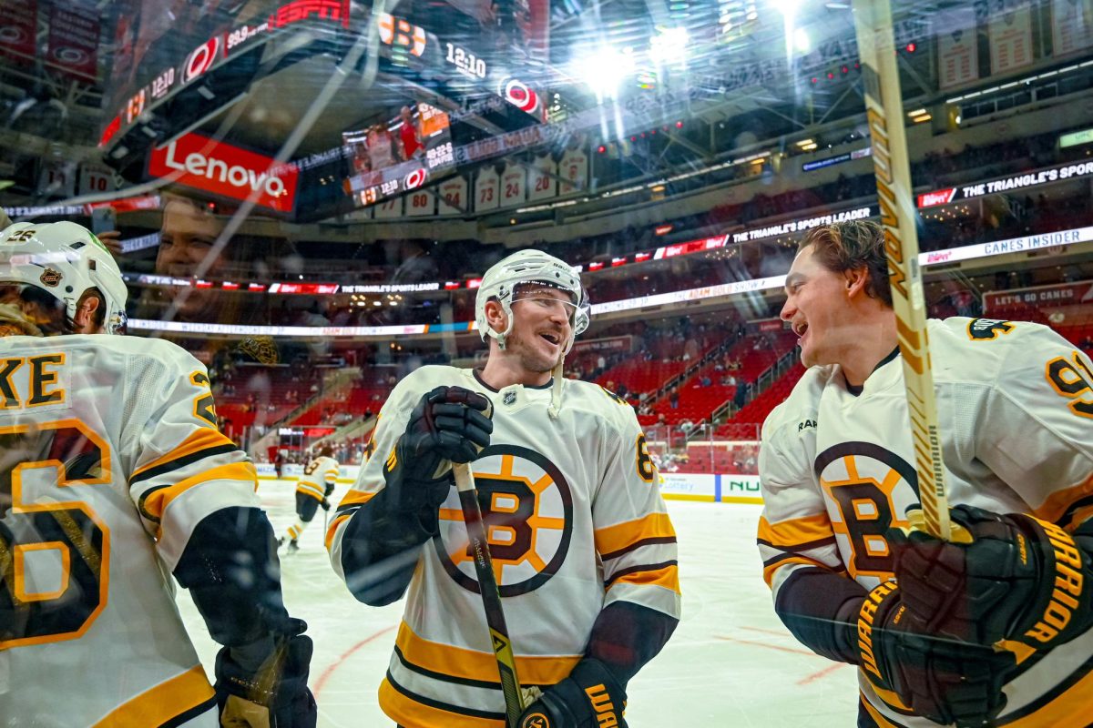 Boston left wing Tanner Jeannot laughs with defenseman Nikita Zadorov and Andrew Peeke during warm ups before the game versus the Carolina Hurricanes at the Lenovo Center on Tuesday, April 7, 2026. The Canes defeated the Bruins in OT 6-5.