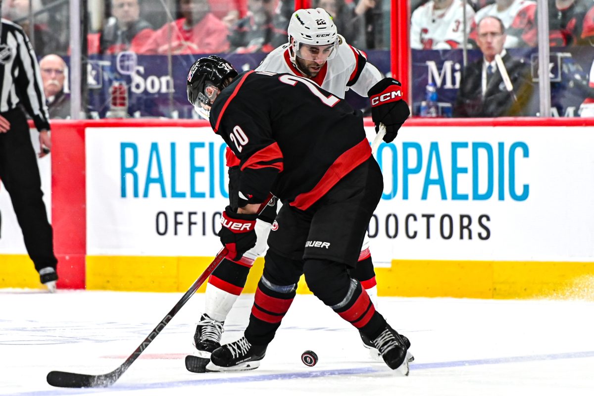 Canes center Sebastian Aho and Senators right wing Michael Amadio battle for the puck during Game One of the Eastern Conference Playoffs at the Lenovo Center on Saturday, April. 18, 2026. The Hurricanes defeated the Senators 2-0.