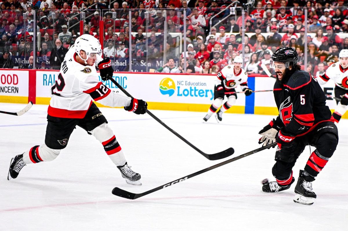 Defenseman Jalen Chatfield attempts to block Senators center Shane Pinto’s shot during Game One of the Eastern Conference Playoffs against the Ottawa Senators at the Lenovo Center on Saturday, April. 18, 2026. The Hurricanes defeated the Senators 2-0.