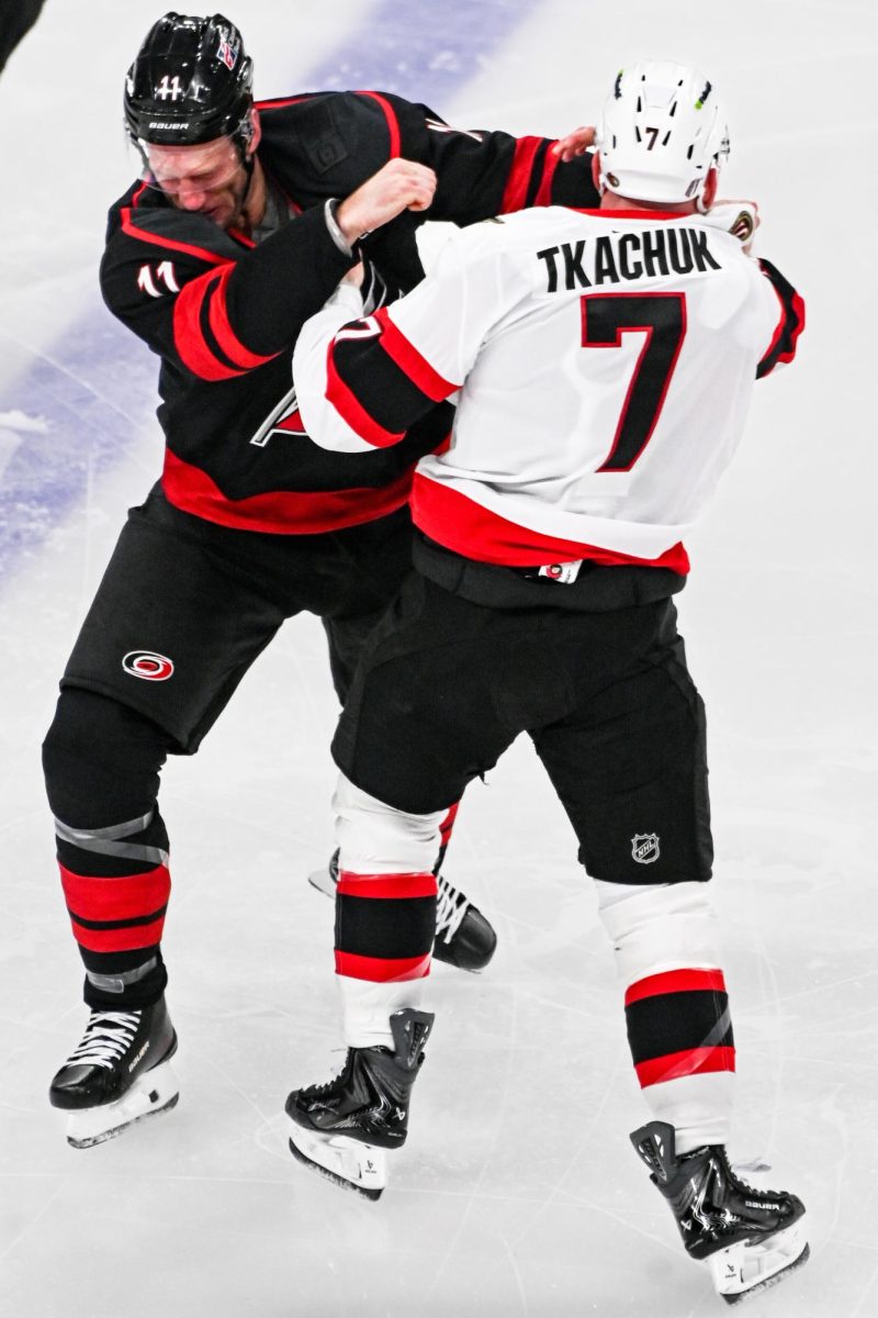 Canes center Jordan Staal and Senators left wing Brady Tkachuk throw down their gloves during the opening face-off of Game One of the Eastern Conference Playoffs at the Lenovo Center on Saturday, April. 18, 2026.  The Hurricanes defeated the Senators 2-0.