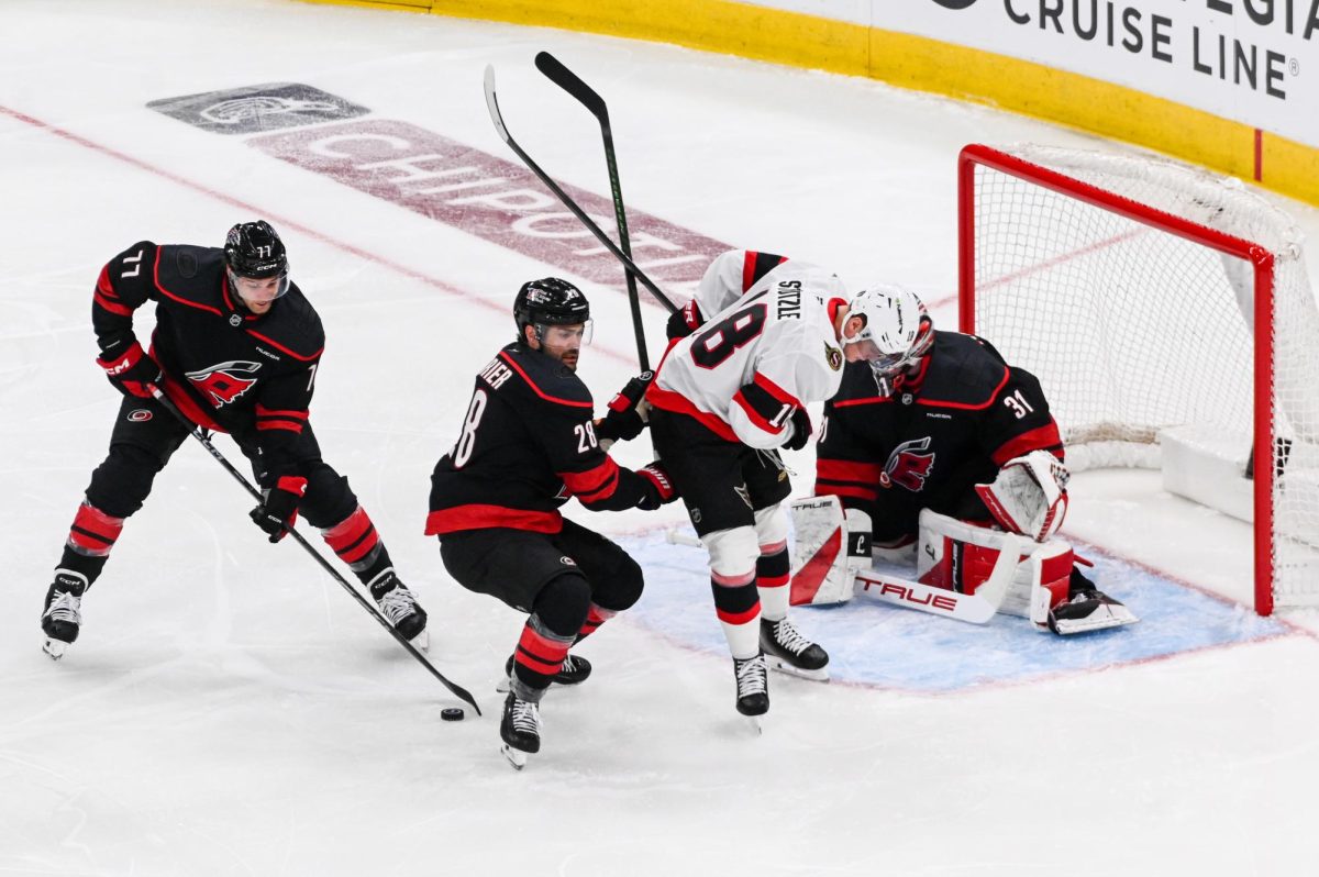 Canes left wingers Mark Jankowski and William Carrier defend the net and gain possession of the puck from Senators center Tim Stützle during Game One of the Eastern Conference Playoffs at the Lenovo Center on Saturday, April. 18, 2026.  The Hurricanes defeated the Senators 2-0.