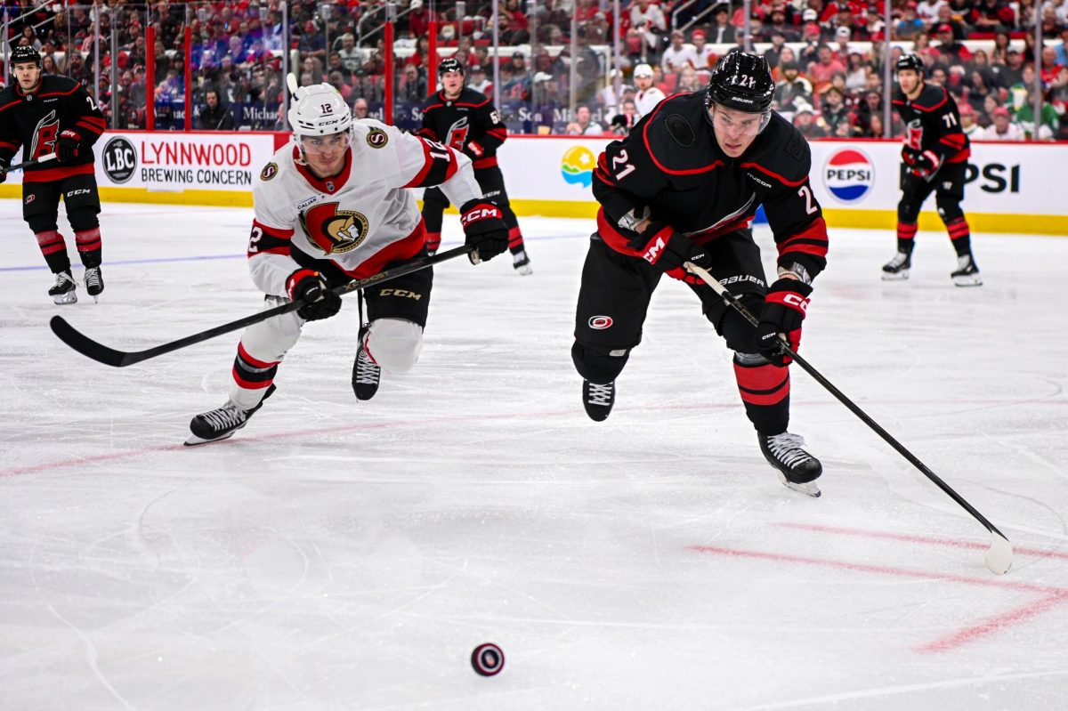 Canes defenseman Alexander Nikishin races Senators center Shane Pinto for the puck in Game One of the Eastern Conference Playoffs at the Lenovo Center on Saturday, April. 18, 2026.  The Hurricanes defeated the Senators 2-0.