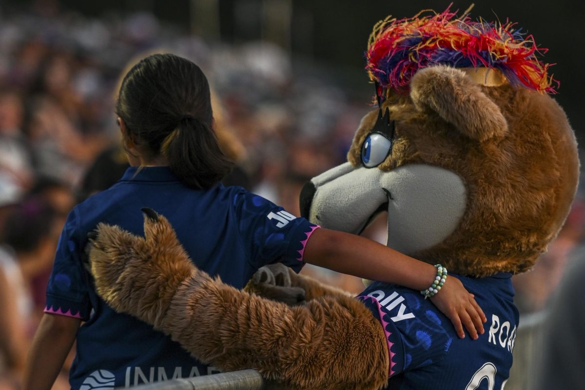Roary the lioness poses for a picture with a young fan during the game versus the Portland Thorns at the WakeMed Soccer Park on Saturday, April. 4, 2026. The NC Courage drew the Portland Thorns 2-2.
