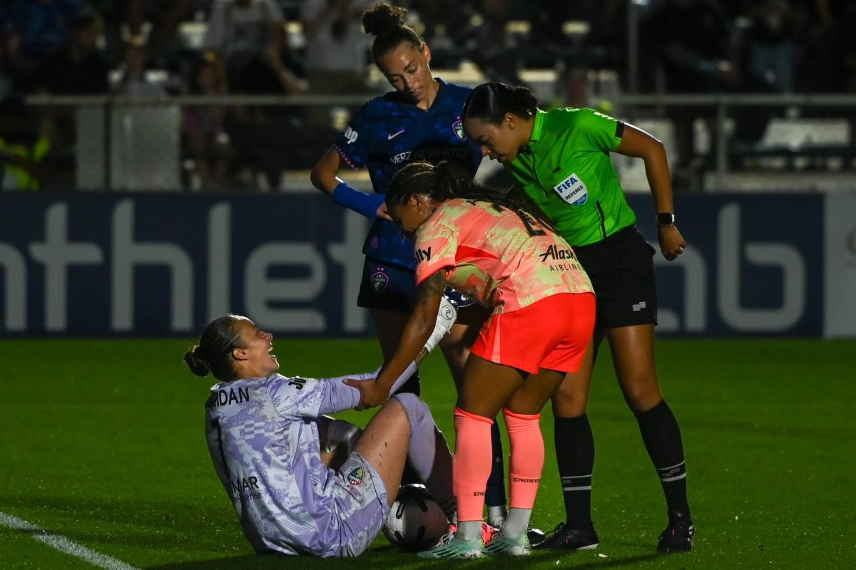 Thorns forward Mimi Alidou helps Courage Goalkeeper Kailen Sheridan stand up after blocking a goal during the game versus the Portland Thorns at the WakeMed Soccer Park on Saturday, April. 4, 2026. The NC Courage drew the Portland Thorns 2-2.