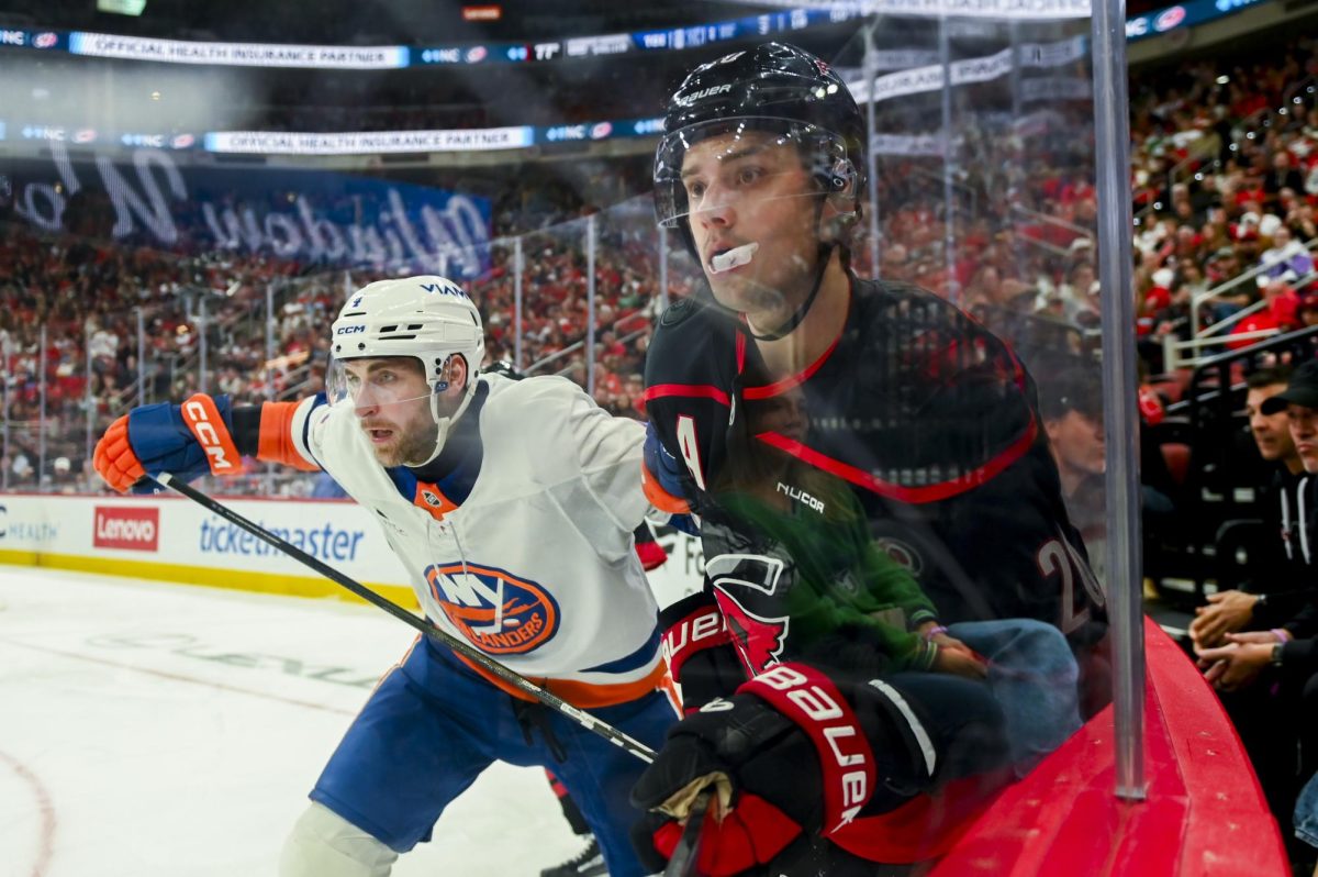 Center Sebastian Aho battles an opponent during the game versus the New York Islanders at the Lenovo Center on Saturday, April 4, 2026. Aho scored one goal for the Hurricanes. The Hurricanes beat the Islanders 4-3.