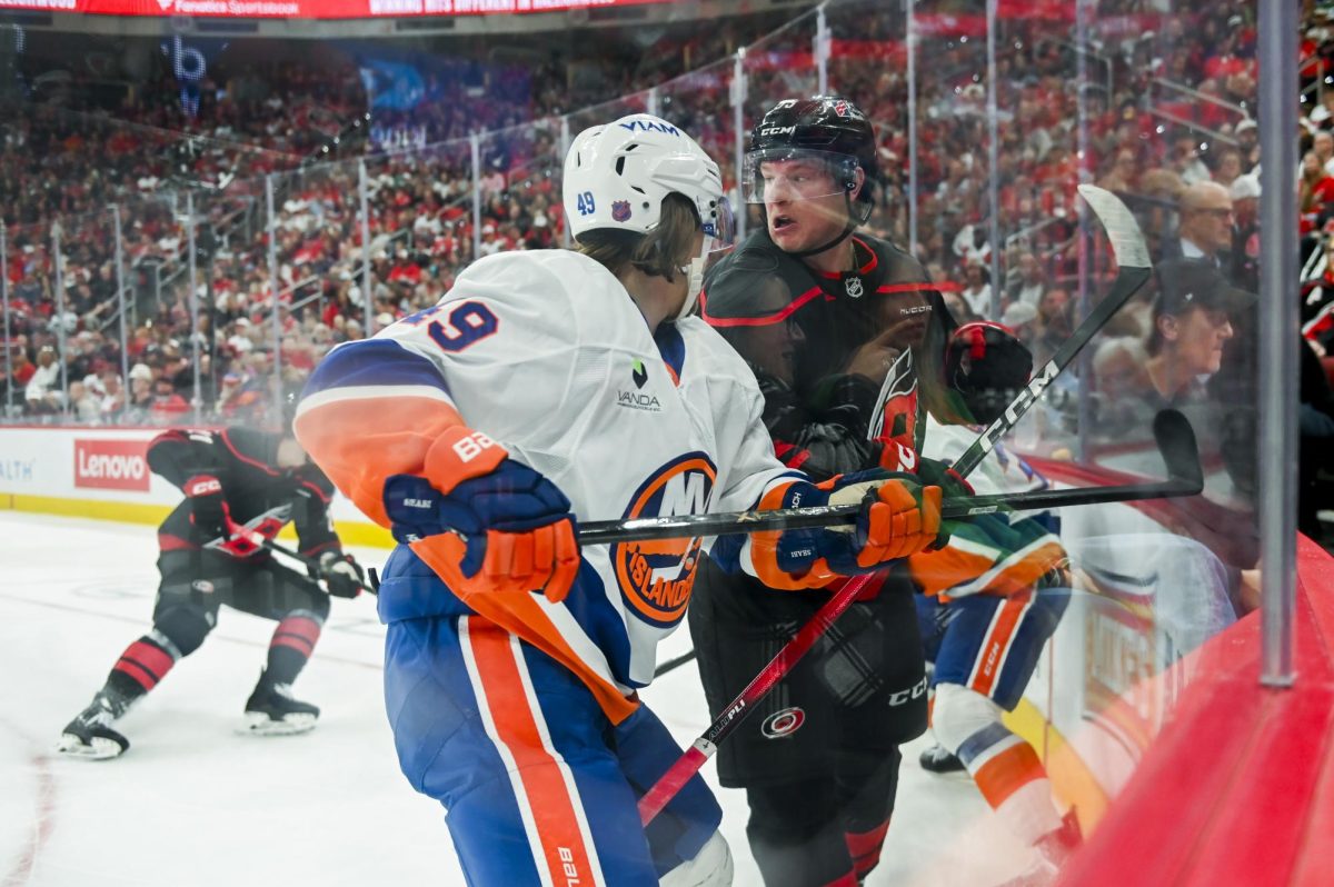 Right wing Jackson Blake battles an opponent during the game versus the New York Islanders at the Lenovo Center on Saturday, April 4, 2026. Blake scored one goal for the Hurricanes. The Hurricanes beat the Islanders 4-3.