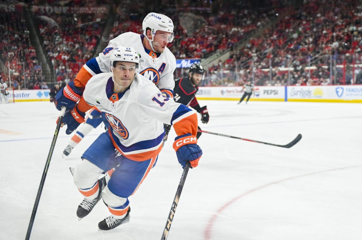 New York Islanders centers Mathew Barzal and Bo Horvat race for the puck during the game versus the Carolina Hurricanes at the Lenovo Center on Saturday, April 4, 2026. The Hurricanes beat the Islanders 4-3.