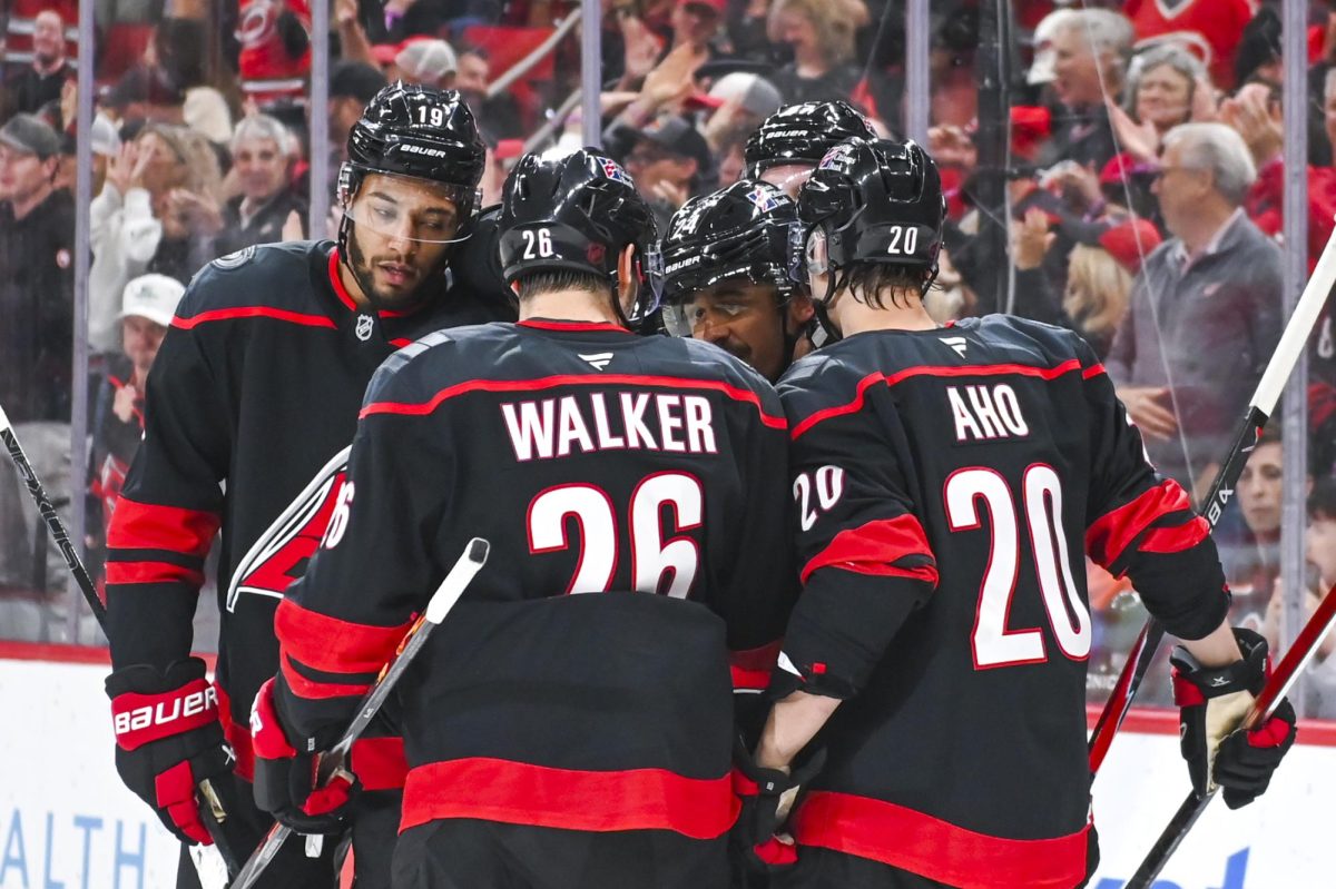 Center Seth Jarvis celebrates with defensemen K'Andre Miller and Sean Walker, center Sebastian Aho, and right wing Andrei Svechnikov after scoring a goal during the game versus the New York Islanders at the Lenovo Center on Saturday, April 4, 2026. Jarvis scored two goals for the Hurricanes. The Hurricanes beat the Islanders 4-3.