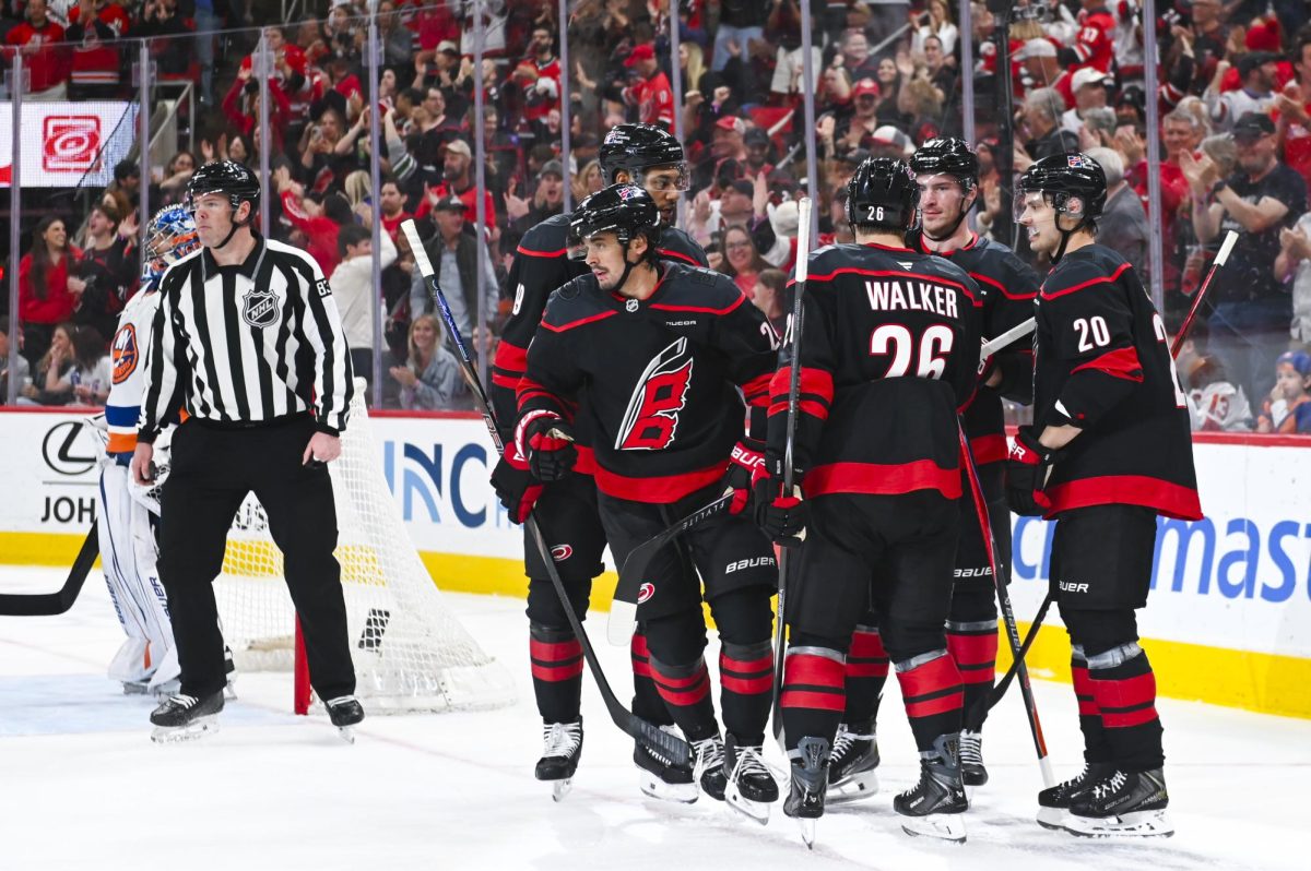 Center Seth Jarvis celebrates with defensemen K'Andre Miller and Sean Walker, center Sebastian Aho, and right wing Andrei Svechnikov after scoring a goal during the game versus the New York Islanders at the Lenovo Center on Saturday, April 4, 2026. Jarvis scored two goals for the Hurricanes. The Hurricanes beat the Islanders 4-3.