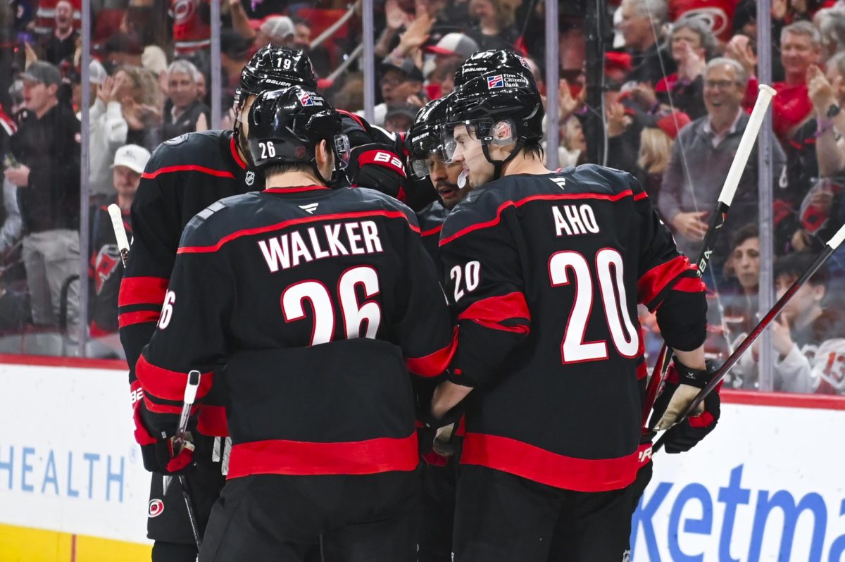 Center Seth Jarvis celebrates with defensemen K'Andre Miller and Sean Walker, center Sebastian Aho, and right wing Andrei Svechnikov after scoring a goal during the game versus the New York Islanders at the Lenovo Center on Saturday, April 4, 2026. Jarvis scored two goals for the Hurricanes. The Hurricanes beat the Islanders 4-3.