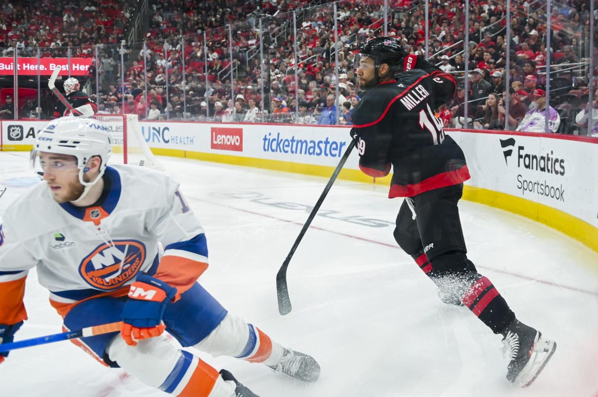 Defenseman K'Andre Miller races for the puck  during the game versus the New York Islanders at the Lenovo Center on Saturday, April 4, 2026. The Hurricanes beat the Islanders 4-3.