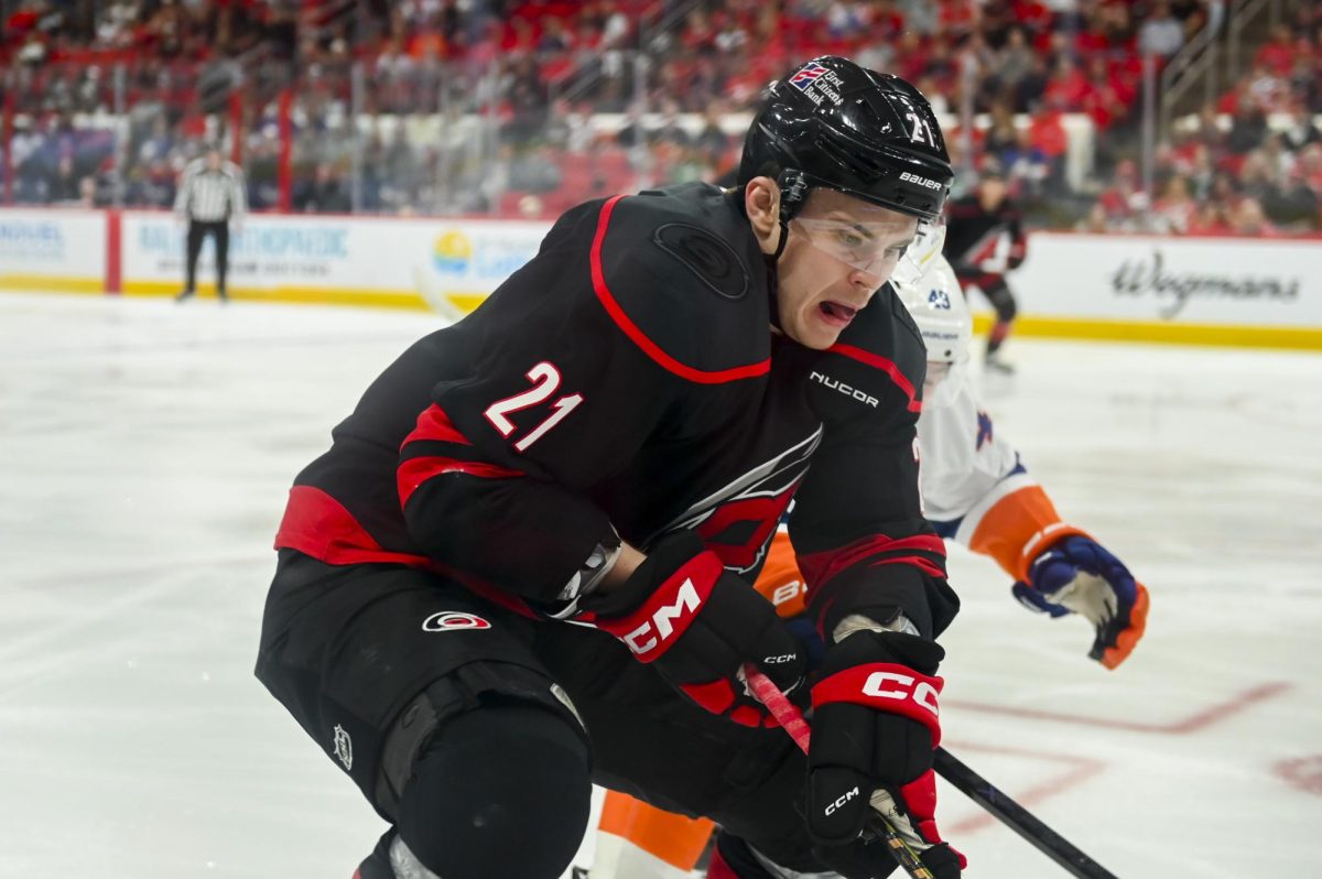 Defenseman Alexander Nikishin battles an opponent for the puck during the game versus the New York Islanders at the Lenovo Center on Saturday, April 4, 2026. The Hurricanes beat the Islanders 4-3.