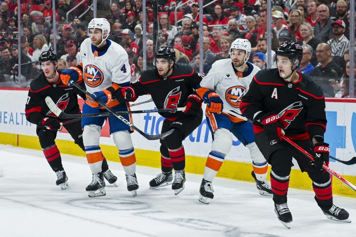 Right wing Andrei Svechnikov, defenseman Sean Walker, and center Sebastian Aho battle opponents for the puck  during the game versus the New York Islanders at the Lenovo Center on Saturday, April 4, 2026. Aho scored one goal for the Hurricanes. The Hurricanes beat the Islanders 4-3.