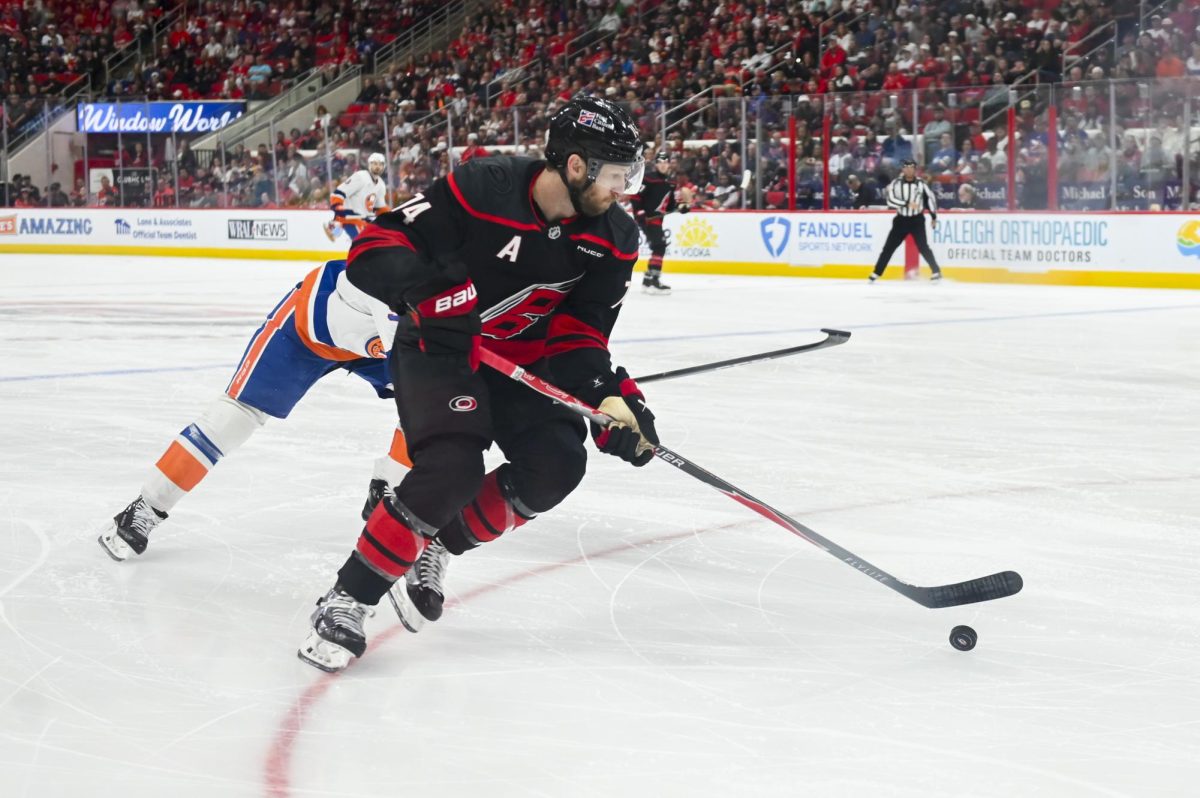 Defenseman Jaccob Slavin guards the puck  during the game versus the New York Islanders at the Lenovo Center on Saturday, April 4, 2026. The Hurricanes beat the Islanders 4-3.