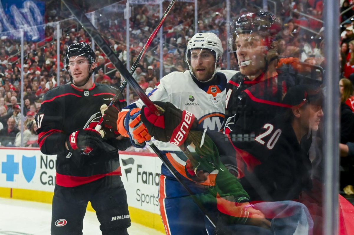 Right wing Andrei Svechnikov and center Sebastian Aho battle an opponent during the game versus the New York Islanders at the Lenovo Center on Saturday, April 4, 2026. Aho scored one goal for the Hurricanes. The Hurricanes beat the Islanders 4-3.