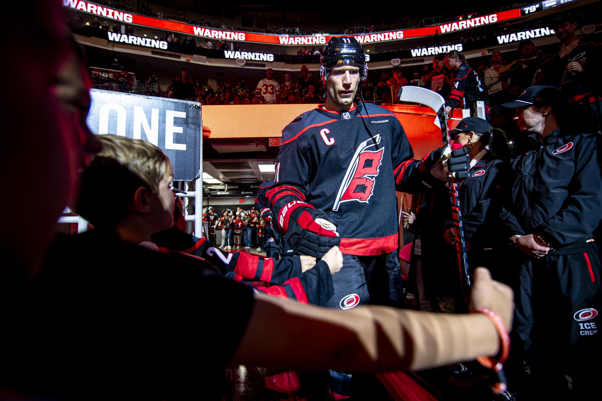 Hurricanes center Jordan Staal high-fives fans while walking out onto the ice before the second period of the game against the Columbus Blue Jackets in the Lenovo Center on Thursday, April 2, 2026. Carolina defeated Columbus 5-1.