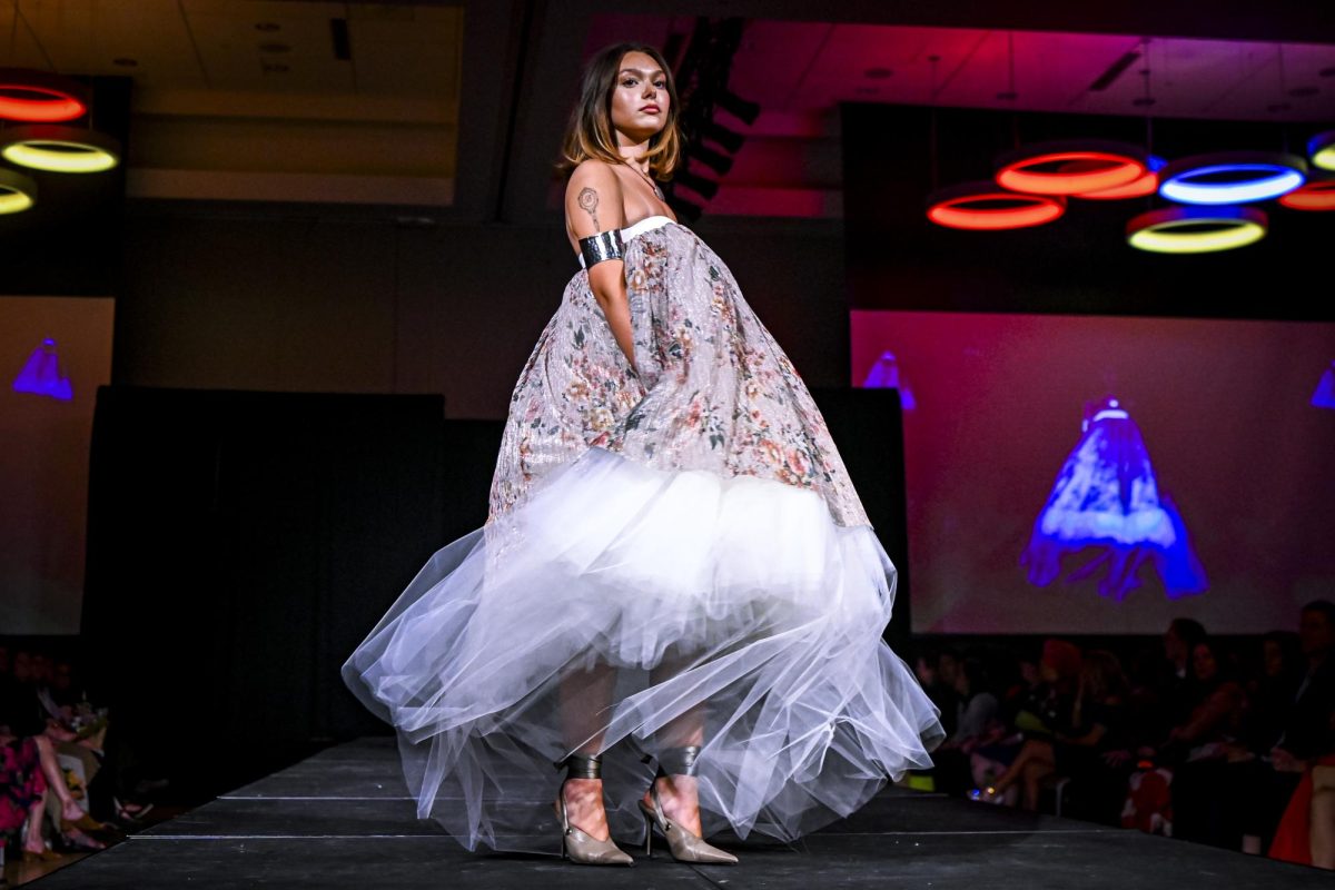 A model walks the runway in a piece from the Illuminare Penumbra collection by Clara Jelenevsky, a fourth-year studying fashion and textile design during the Emerging Designers Runway Show and Textile Showcase at Talley State Ballroom on Saturday, April 25, 2026.