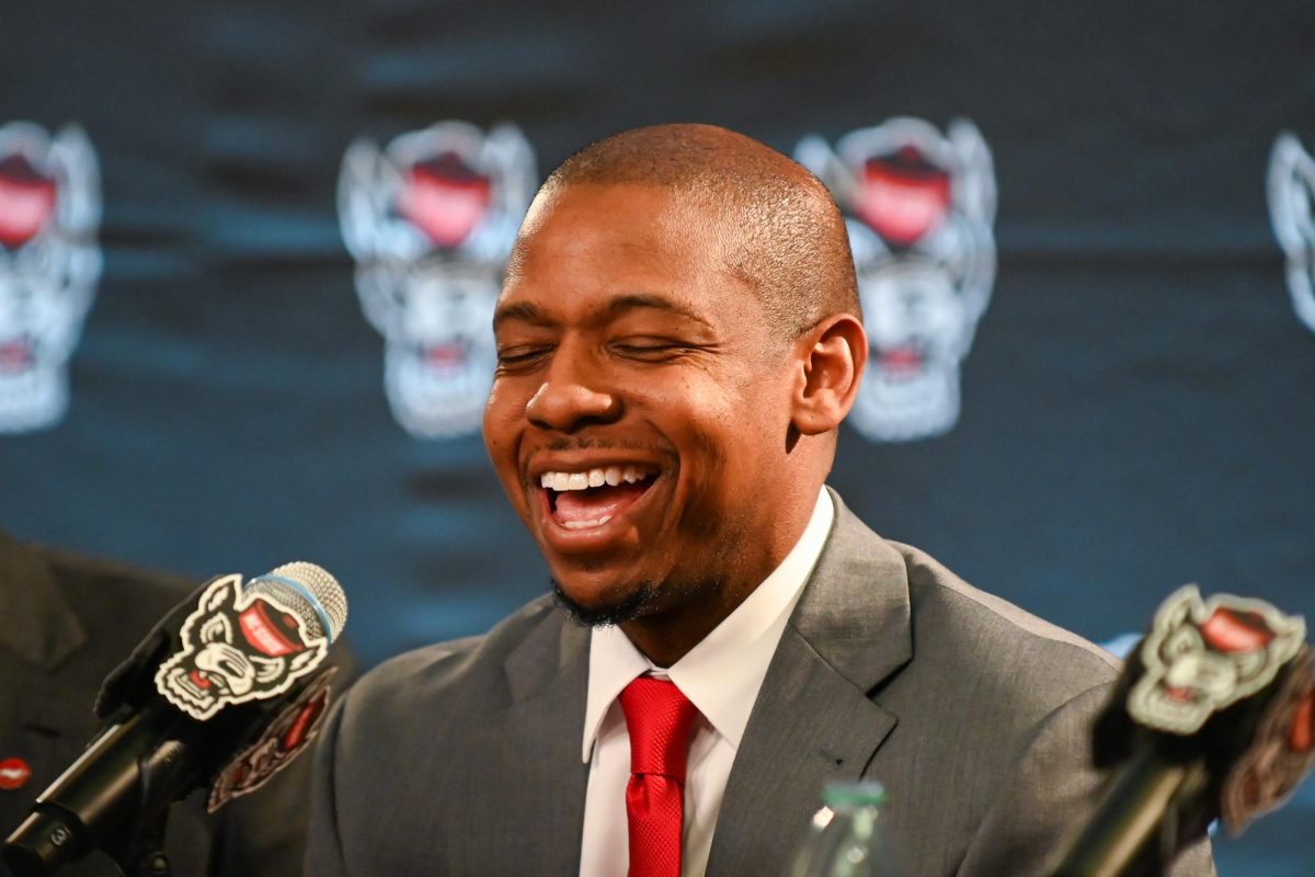 Justin Gainey, NC State men's basketball head coach, laughs during his introduction press conference at The Lenovo Center on Wednesday April 1, 2026. The event was held for new NC State head coach Justin Gainey and hosted by NC State athletics.