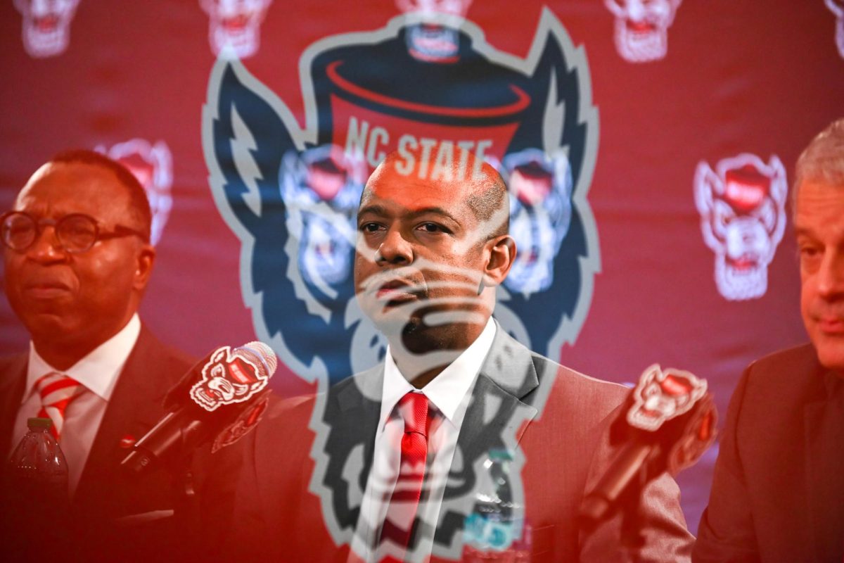 Justin Gainey, NC State men's basketball head coach, looks into the crowd during his introduction press conference at The Lenovo Center on Wednesday April 1, 2026. The event was held for new NC State head coach Justin Gainey and hosted by NC State athletics. (Double exposure photo)