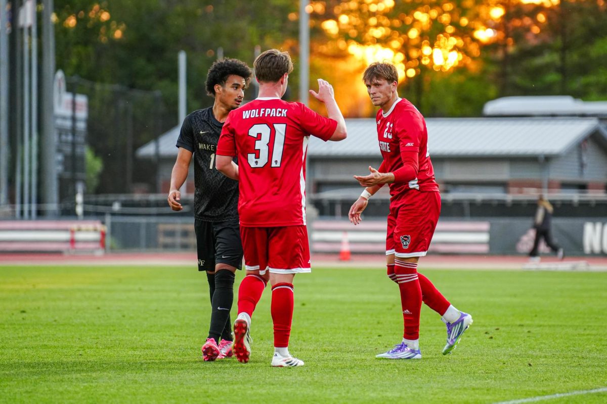 Sophomore midfielder John Pottle daps up senior forward Austin Bush during the game against Wake Forest at Dail Soccer Field on Tuesday, April 7, 2026. NC State beat Wake Forest 3-0.
