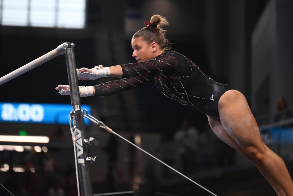 Junior Elle Hadrick jumps in her uneven bar routine at the NCAA Regional meet against Arkansas, Mizzou, and Maryland at Memorial Coliseum on Friday, Apr. 3, 2026. The Wolfpack fell to the Razorbacks and Tigers with a score of 195.700, marking the end of their 2026 season.