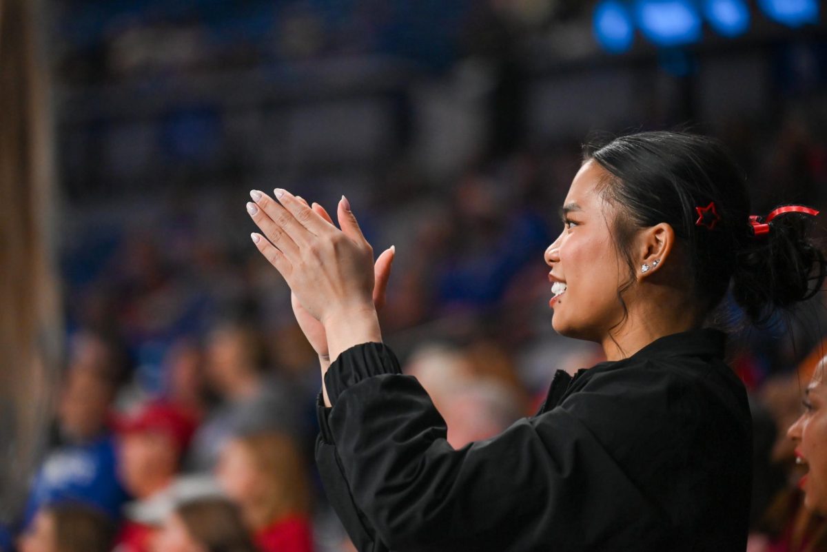 Junior Maddie Hall cheers during sophomore Syniya Thomas' floor routine at the NCAA Regional meet against Arkansas, Mizzou, and Maryland at Memorial Coliseum on Friday, Apr. 3, 2026. The Wolfpack fell to the Razorbacks and Tigers with a score of 195.700, marking the end of their 2026 season.