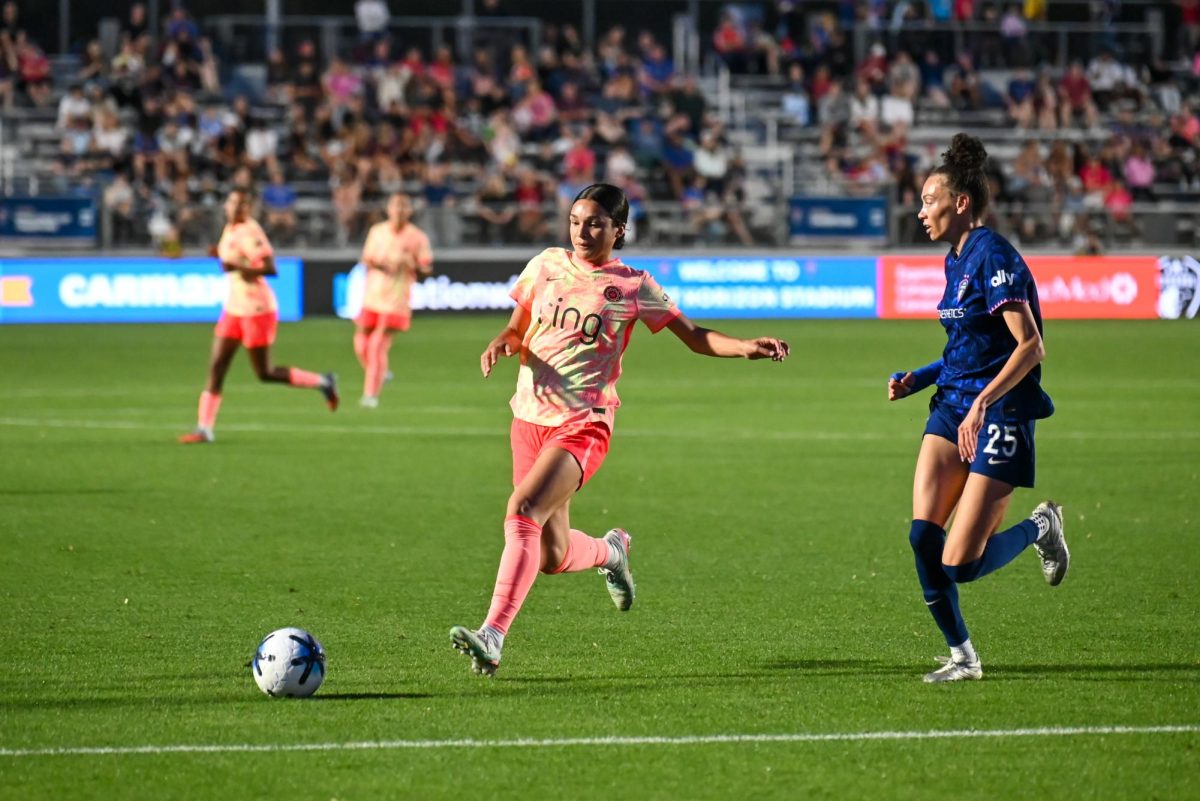 Defender Mayce Bell and Portland Thorns forward Sophia Wilson run for the ball during the game between the North Carolina Courage and Portland Thorns at First Horizon Stadium on Saturday, Apr. 4, 2026. Bell was a defensive force in the game and was named the Muscle and Hustle player of the match. Courage tied the thorns 2-2.