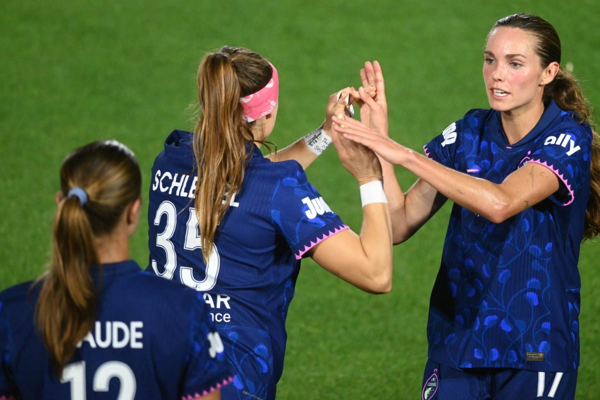 Midfielder Dani Weatherholt and forward Ally Schlegel high-five during the game between the North Carolina Courage and Portland Thorns at First Horizon Stadium on Saturday, Apr. 4, 2026. Courage tied the thorns 2-2.